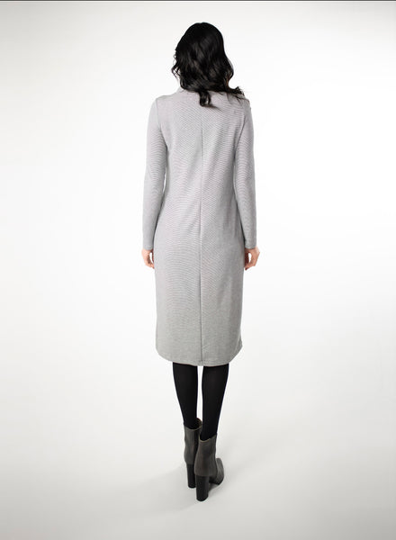Grey and white striped dress with full length sleeve and mock neck. With black tights and heels.