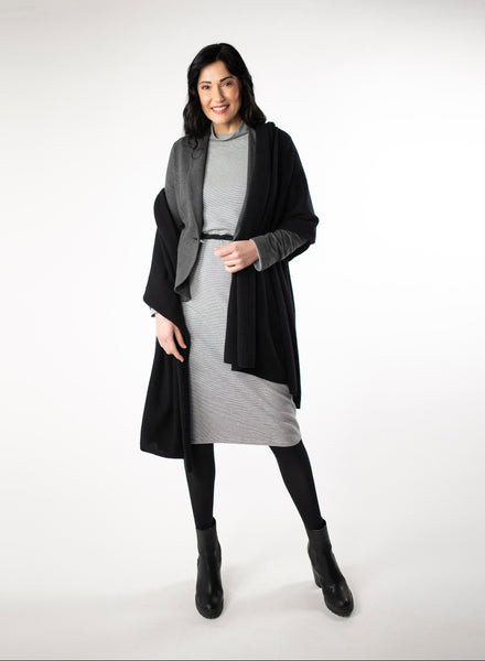 Grey and white striped dress with full length sleeve and mock neck. Black belt around waist. Charcoal Grey open blazer and black cashmere shawl