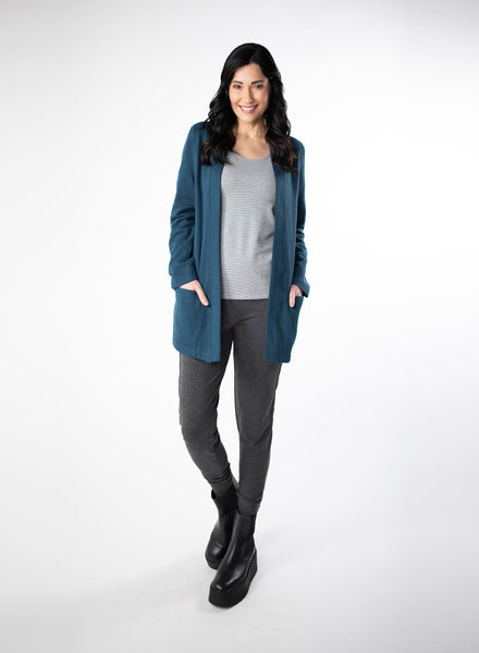 Deep Blue Fleece Cardigan with reverse fabric trim. Front pockets at hip. Styled with Grey and White stripe top fitted tank and charcoal pants.