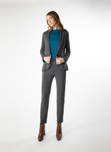 Charcoal Grey Tailored Blazer in Bamboo knit fabric with a wood button at front closure. Styled with Charcoal Grey pants and Blue ribbed mock neck.