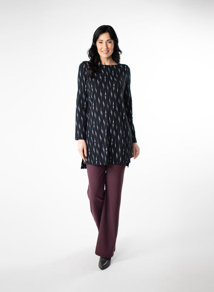 Black and White patterned tunic with step hem and boat neckline. Styled with Plum fleece wide leg pants. 