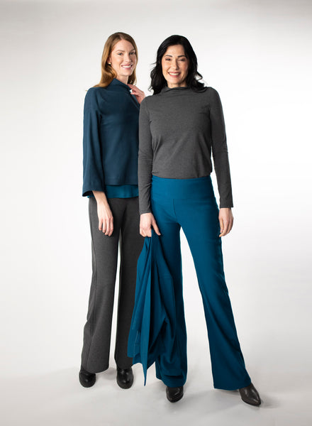 Two Models wearing co-ordinating colours. Model 1 in Charcoal grey fleece pants and blue waffle knit cropped mock neck sweater. Model 2 in Blue fleece pants and charcoal mock neck