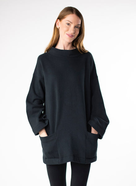 Black Organic Cotton Fleece tunic length sweater with full sleeves. Features front pockets and wide collar. 
