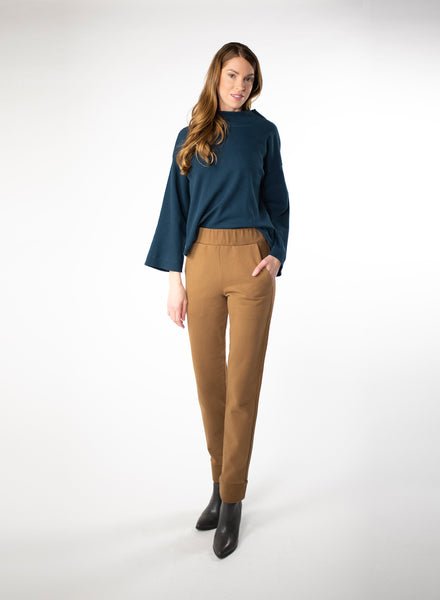 Deep blue waffle knit cropped sweater. Wide mock neck style neckband and full sleeves. Styled with Nutmeg trousers.