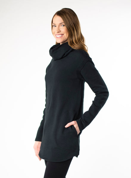 Black organic cotton fleece sweater with side seam pockets and a fitted hood. Reverse fabric details on seams and curved hem.