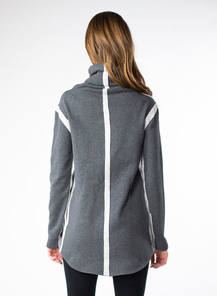 Charcoal Grey organic cotton fleece sweater with side seam pockets and a fitted hood. Reverse fabric details on seams and curved hem.