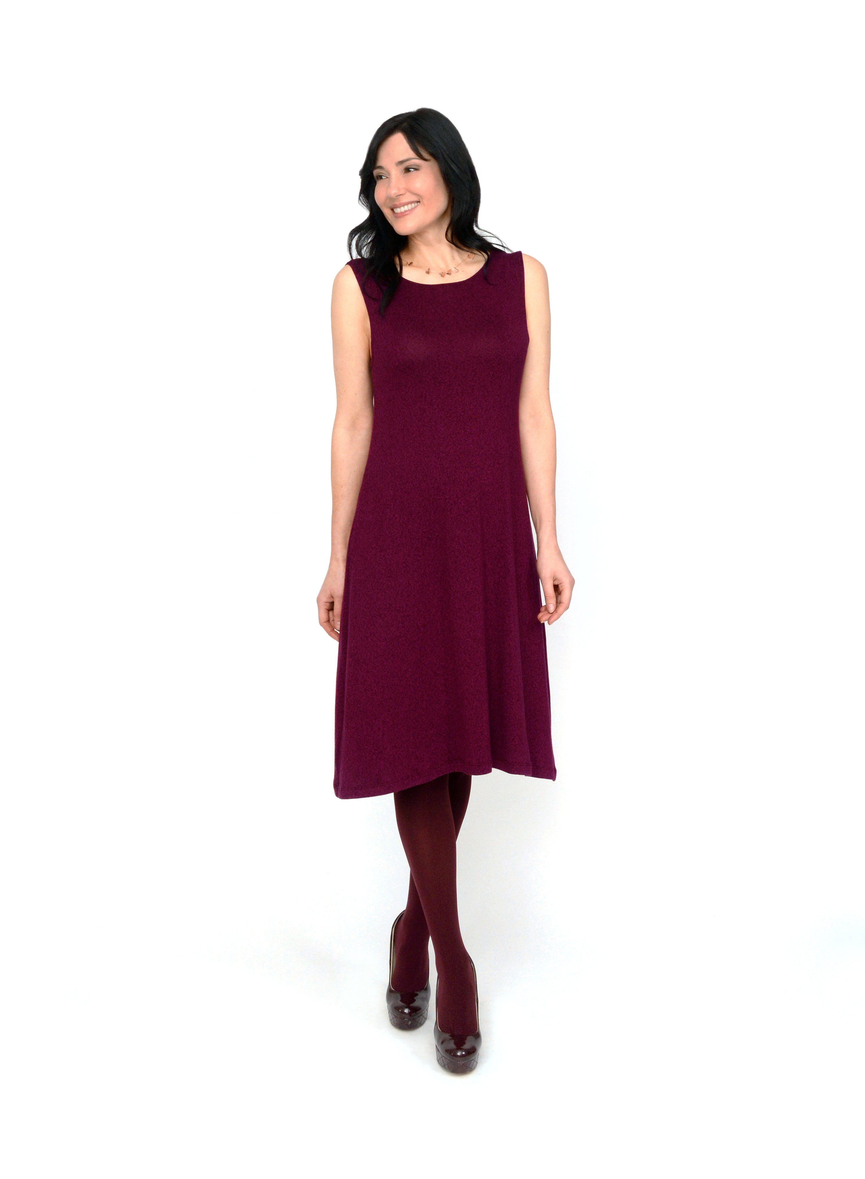 Burgundy reversible neckline tank dress. Two-way neckline showing the boat neck in front. Dress length ends below the knee. Tencel Modal blend lux fabric.