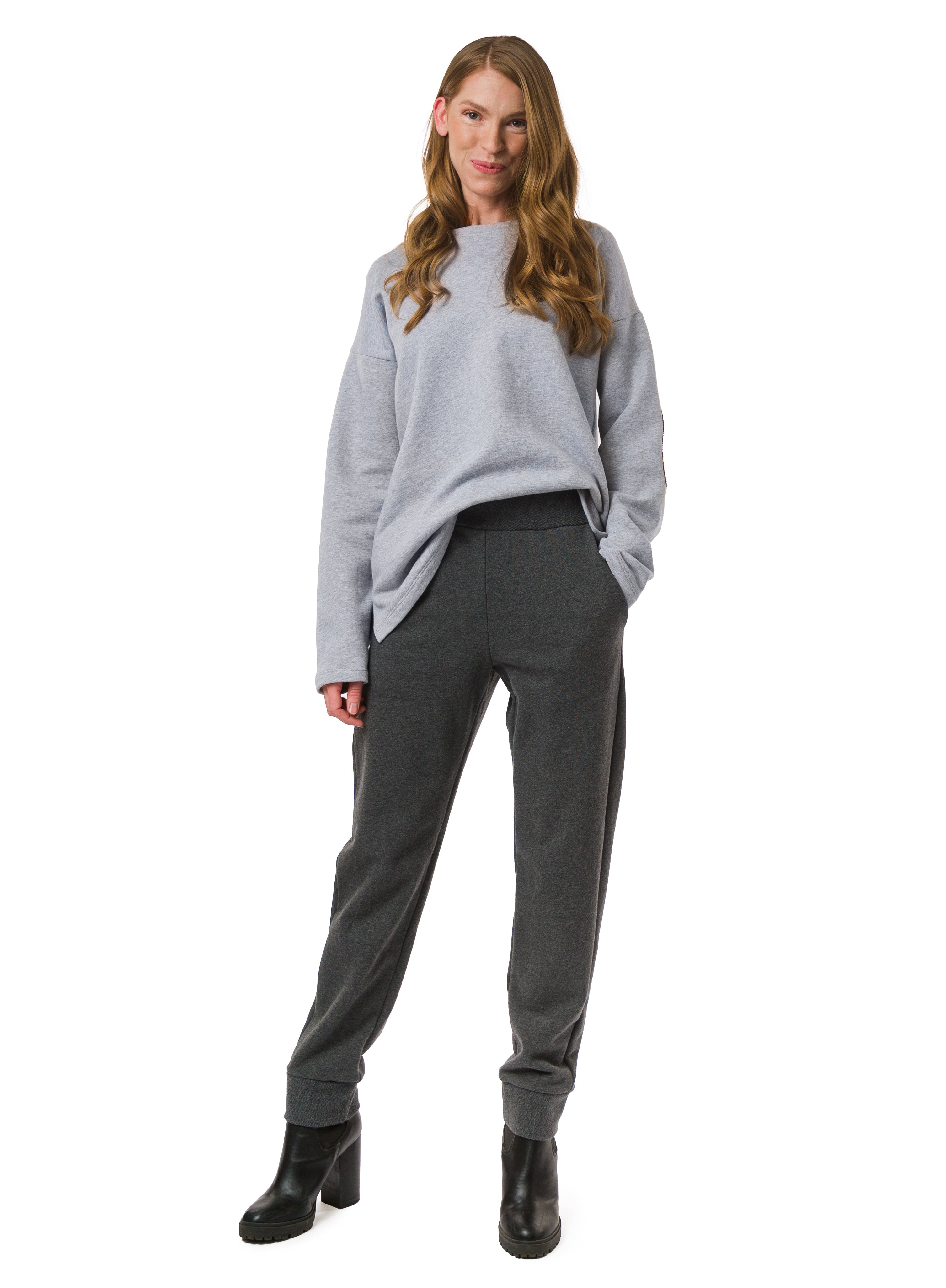 Charcoal Grey Organic Cotton unisex trouser. Reverse fabric waistband, pocket and cuff details. Styled with Light Grey Sweater.