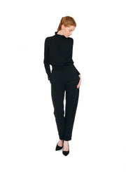 Black unisex mock neck, fitting close to the body with full length sleeves. Styled with Black unisex trousers.