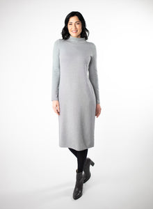 Grey and white striped dress with full length sleeve and mock neck. With black tights and heels.