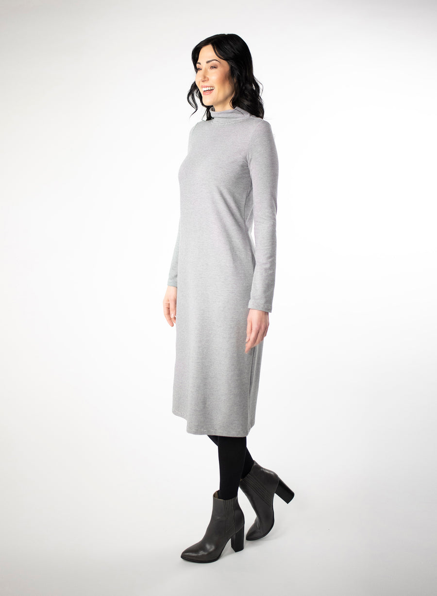 Grey and white striped dress with full length sleeve and mock neck. With black tights and heels.