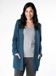 Deep Blue Fleece Cardigan with reverse fabric trim. Front pockets at hip. Styled with Grey and White stripe top fitted tank and charcoal pants.