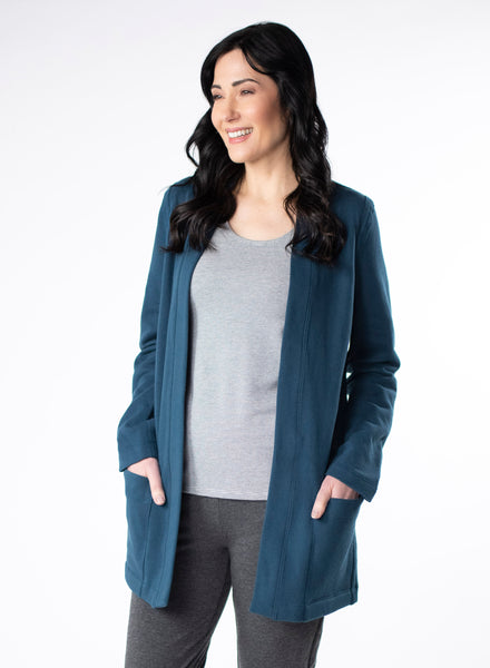Deep Blue Fleece Cardigan with reverse fabric trim. Front pockets at hip. Styled with Grey and White stripe top fitted tank and charcoal pants.