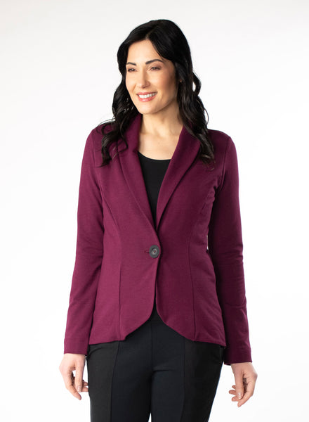 Burgundy Tailored Blazer in Bamboo knit fabric with a wood button at front closure. Styled with black scoop neck top and black pants.
