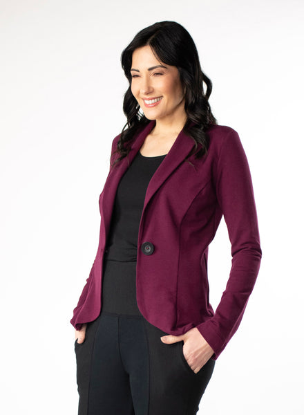 Burgundy Tailored Blazer in Bamboo knit fabric with a wood button at front closure. Styled with black scoop neck top and black pants.