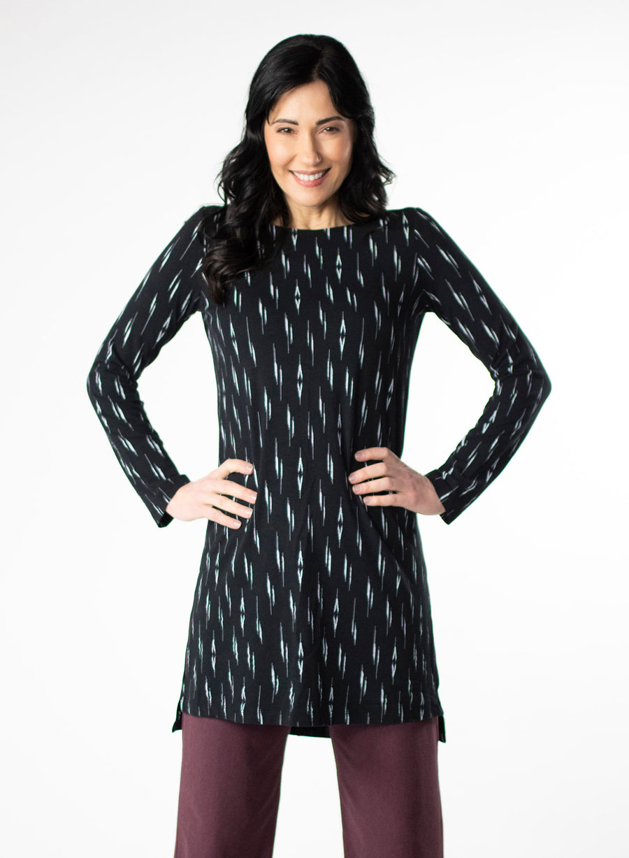 Black and White patterned tunic with step hem and boat neckline. Styled with Plum fleece wide leg pants. 