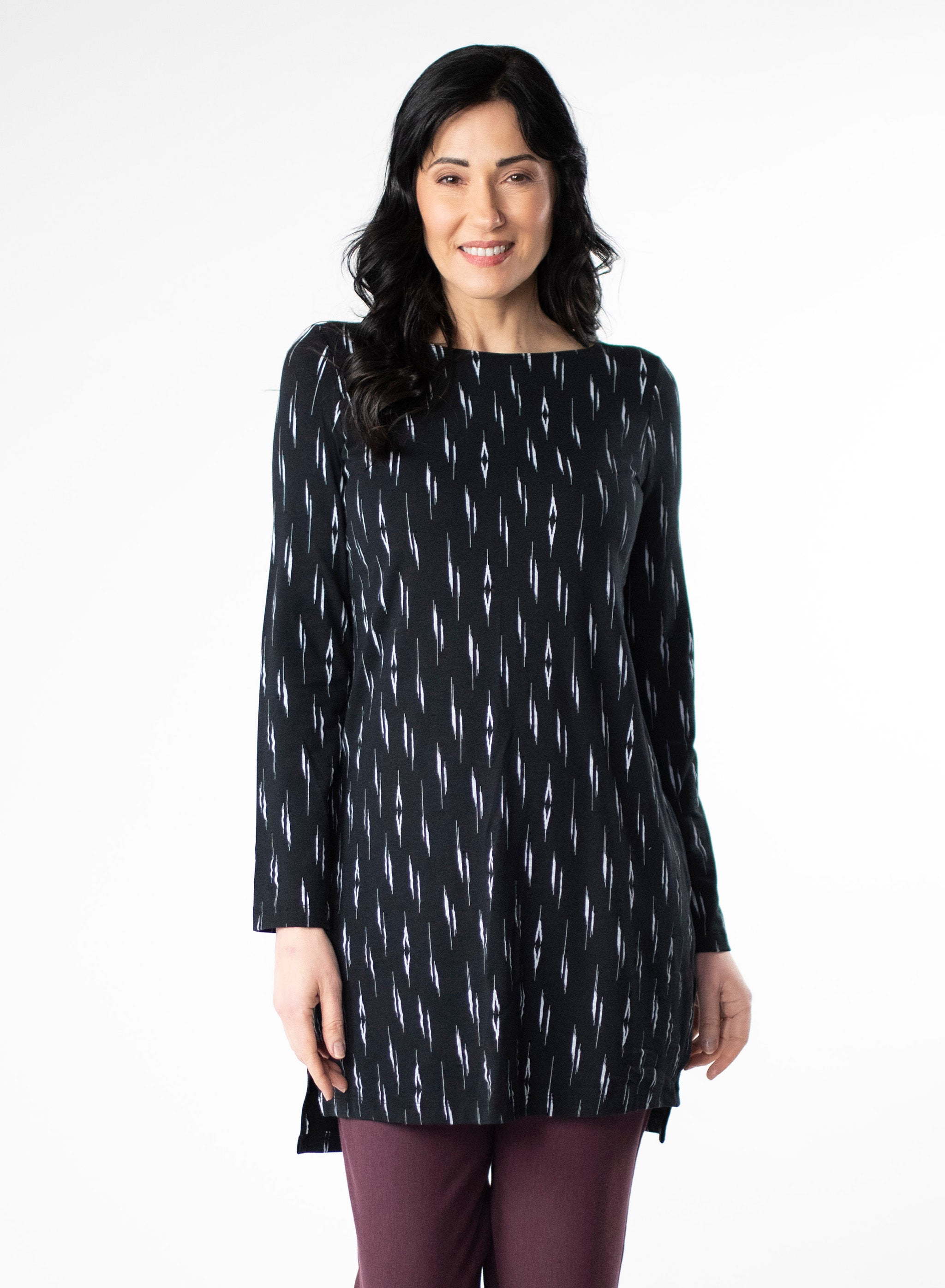 Black and White patterned tunic with step hem and boat neckline. Styled with Plum fleece wide leg pants. 