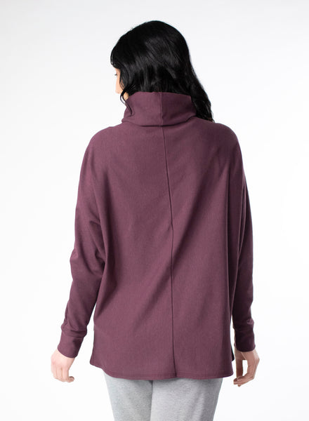 Plum fleece sweater with cowl neck and dolman cuffed sleeves. Seam in centre back. 