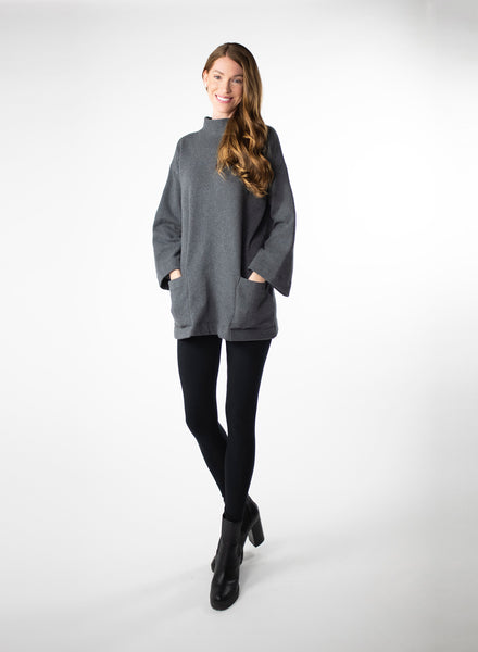 Charcoal Grey Organic Cotton Fleece tunic length sweater with full sleeves. Features front pockets and wide collar. Styled with black leggings