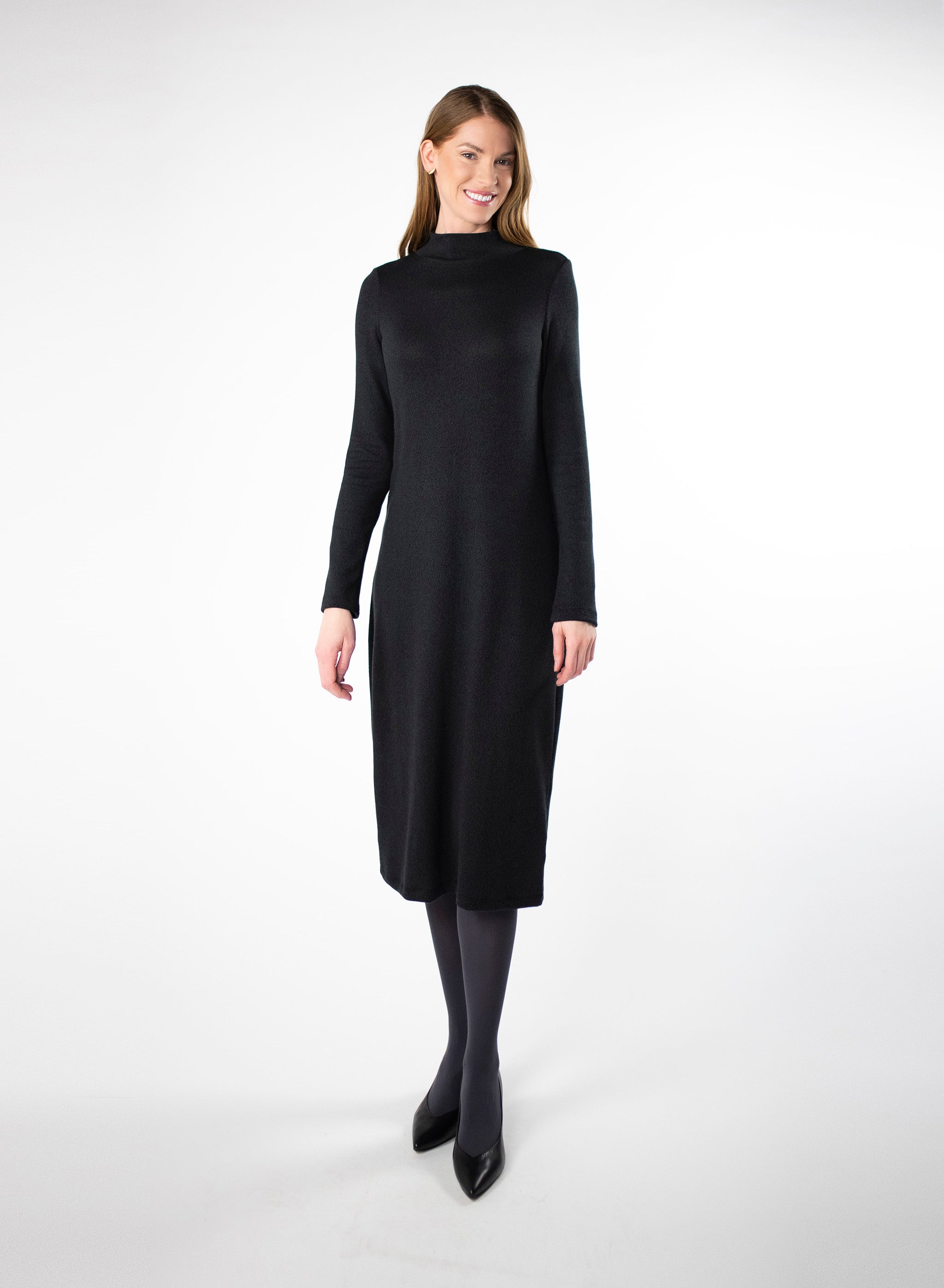 Black mock neck dress with full length sleeves. Dress length ends below the knee. Styled with Charcoal Grey leggings. Tencel Modal blend lux fabric.