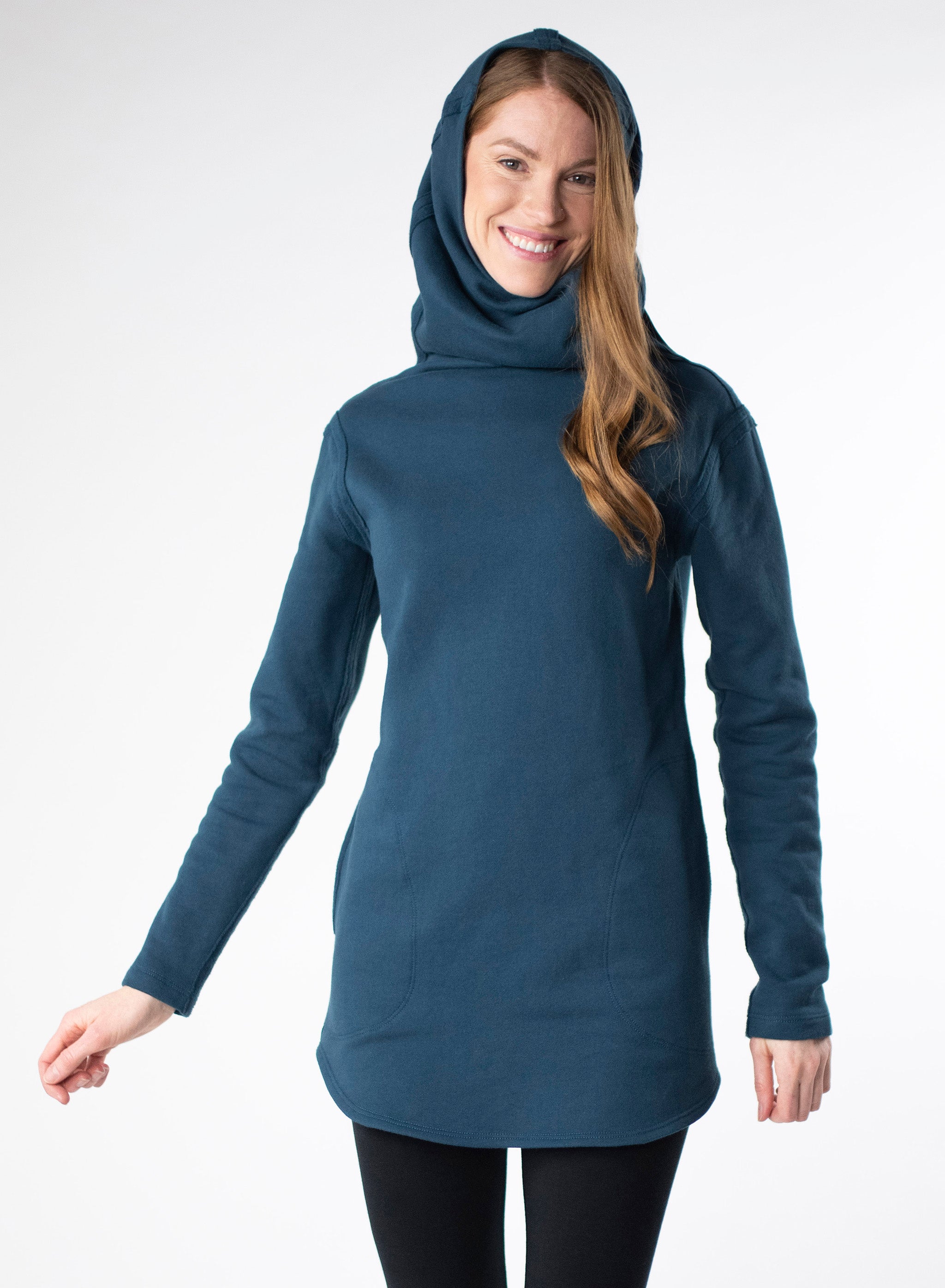 Deep Blue organic cotton fleece sweater with side seam pockets and a fitted hood. Reverse fabric details on seams and curved hem.