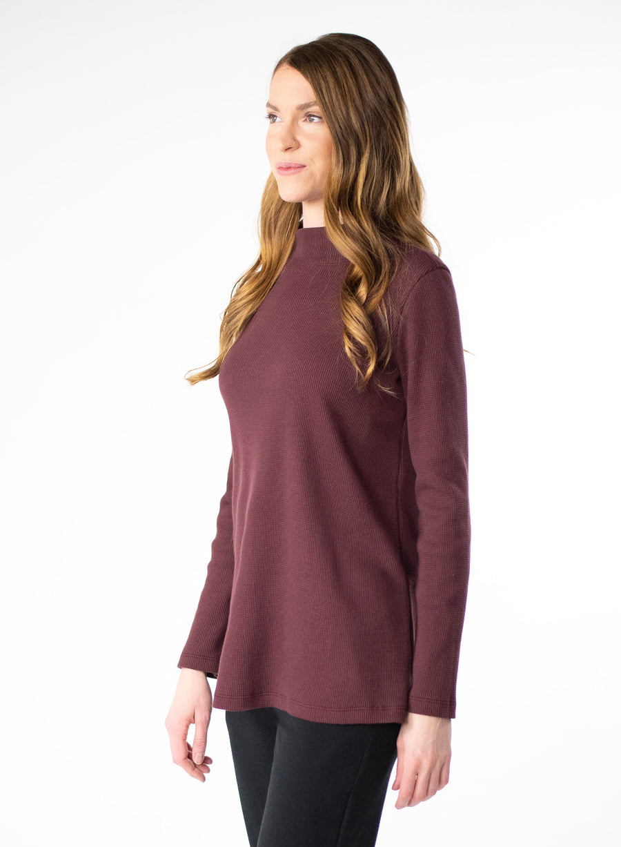 Plum organic cotton waffle knit mock neck. Loose fit to the body.