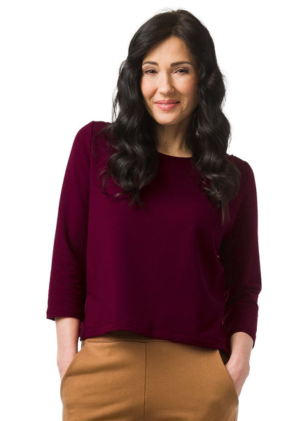 Burgundy hip length top with 3/4 length sleeve. Pin tuck on shoulder seam. Bamboo and Cotton fabric. Styled with nutmeg coloured pants