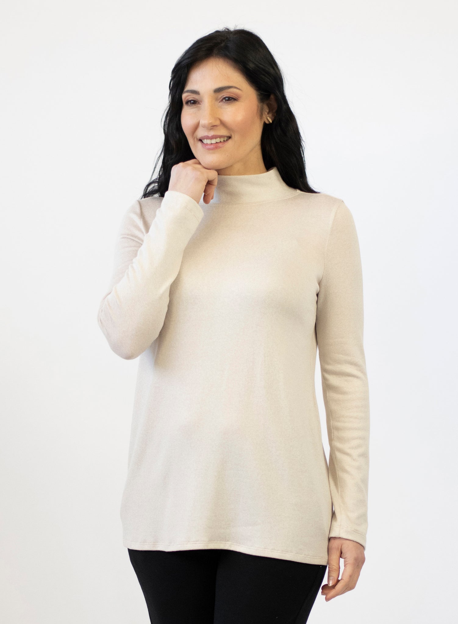 Cream mock neck fitting loose to the body with full length sleeves. Tencel Modal blend lux fabric