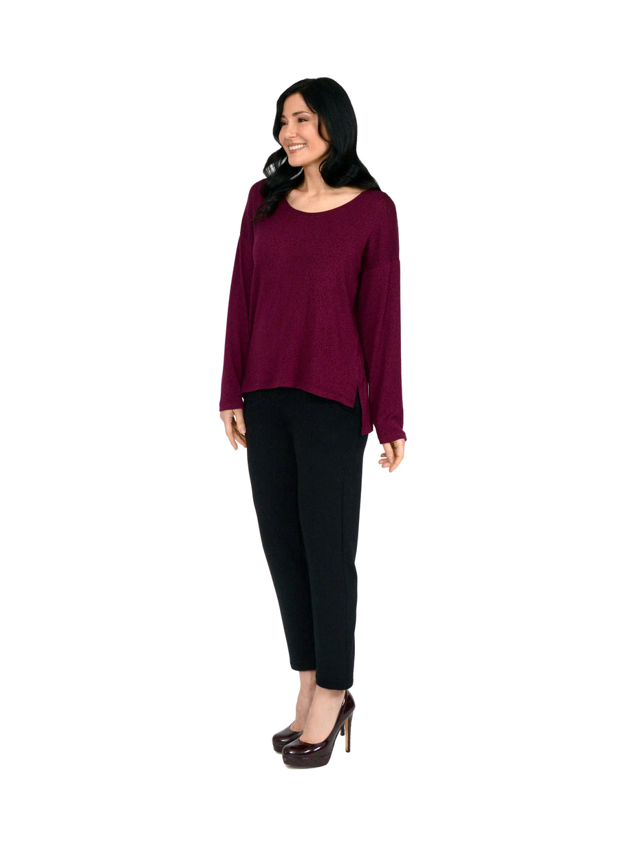 Burgundy long sleeve top with boat neck and relaxed fit to the body. Step hem with a small side slit. Tencel Modal blend lux fabric. Styled with black trousers