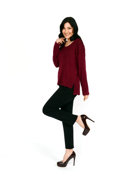 Burgundy long sleeve top with boat neck and relaxed fit to the body. Step hem with a small side slit. Tencel Modal blend lux fabric. Styled with black trousers