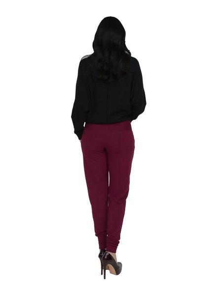 Burgundy fitted casual pant with side pockets, wide waistband and cuff and the ankles. Styled with Black sweater