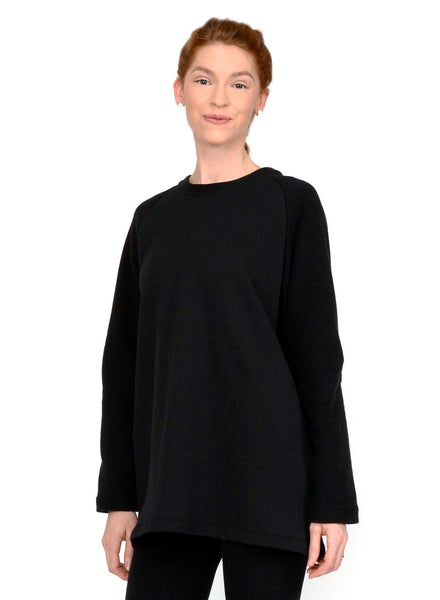 Black unisex sweater with reverse fabric sleeves and neck band. Pintuck detail on elbow.